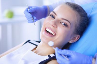 A smiling woman getting a dental exam