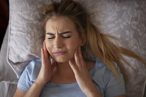A woman with jaw pain