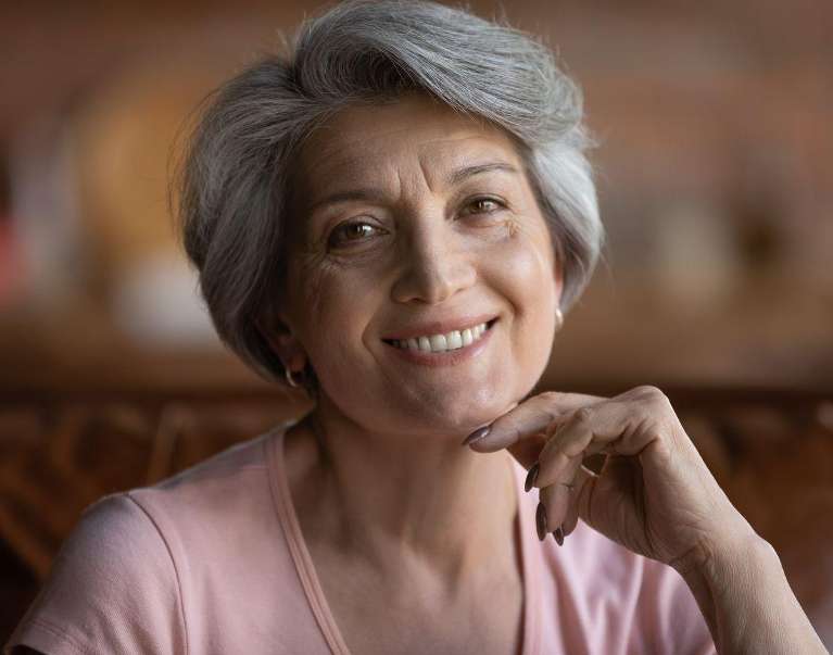 A smiling woman with dental implants in langhorne