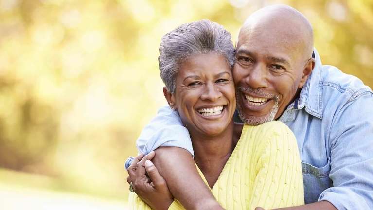 A smiling older couple with dentures